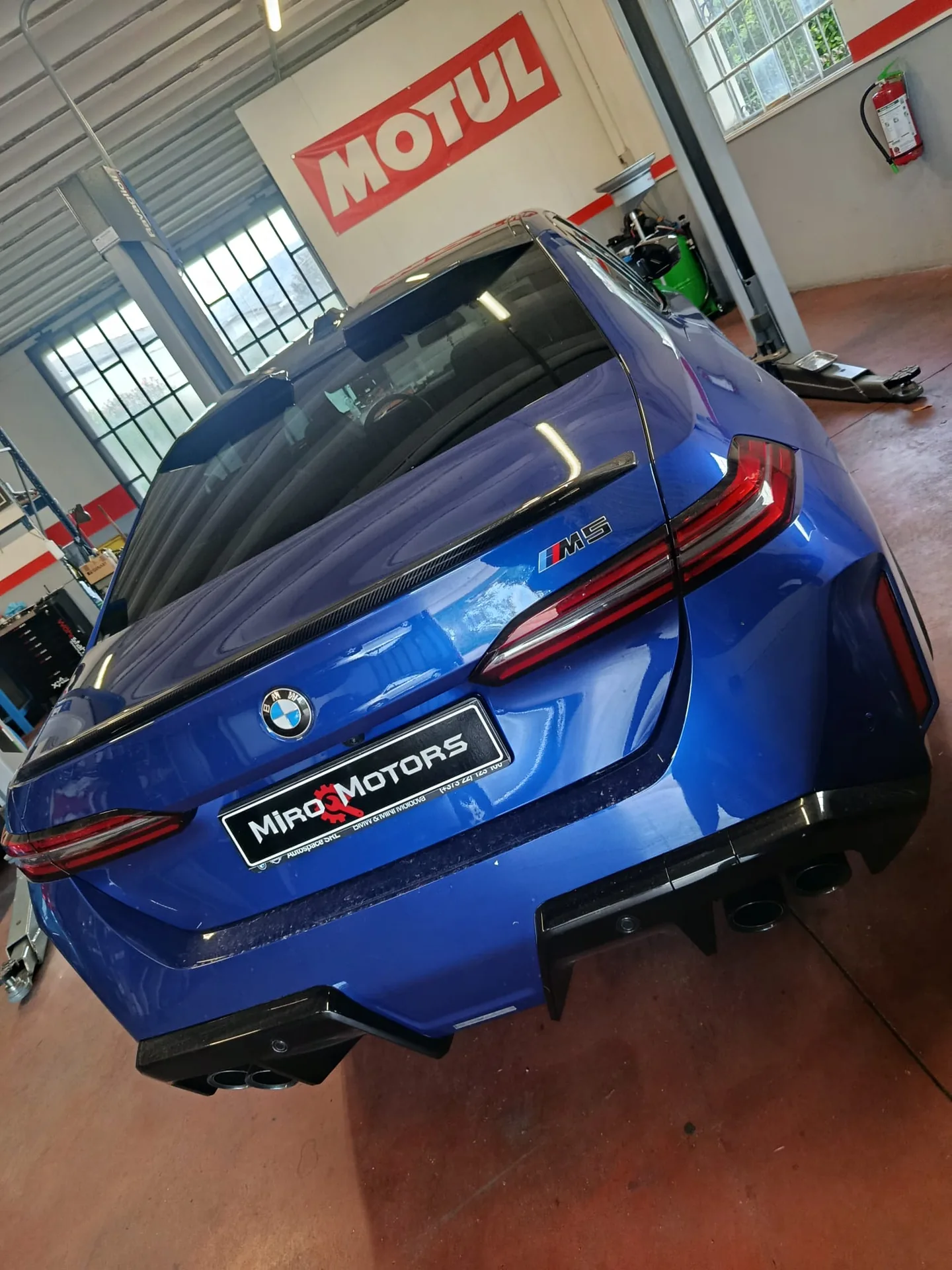 Dettaglio del posteriore di una BMW M5 blu con vetri oscurati